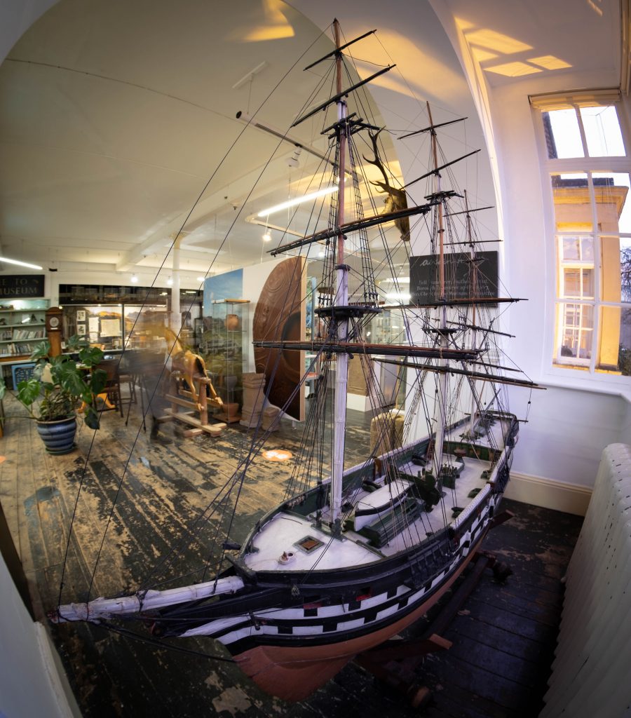 A picture of the sailing boat in the westmorland gallery. It has lots of masts and is made out of wood.